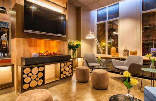 a lobby with a fireplace and a flat screen tv at Leonardo Boutique Hotel Amsterdam Vondelpark in Amsterdam