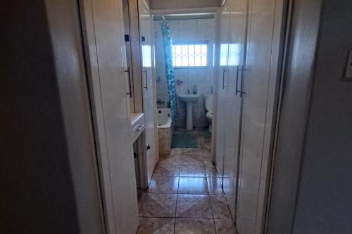 a bathroom with a toilet and a sink and a tub at Bulawayo Bliss - Cozy 3 Bedroom House in Bulawayo