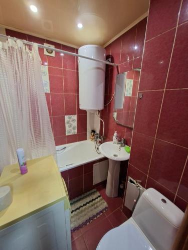 a bathroom with a white toilet and a sink at Терновской район in Kryvyi Rih