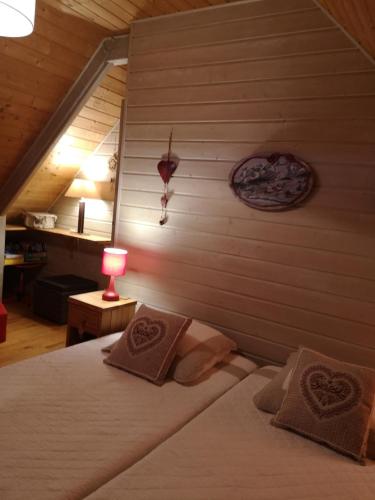 a bedroom with a bed and a table with a lamp at chalet besse en chandese in Besse-et-Saint-Anastaise