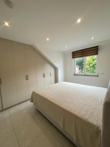 a bedroom with a large bed with a window at Stylish spacious residence in Düsseldorf in Düsseldorf