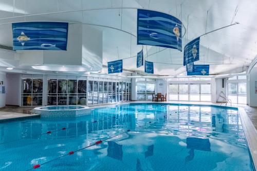 a large pool with blue water in a building at Bromsgrove Hotel in Bromsgrove