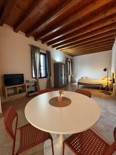 a room with a table and chairs and a bed at Vittoria in Brescia