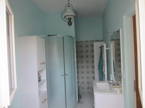 a bathroom with a white cabinet and a sink at piedameretnature in Lagord