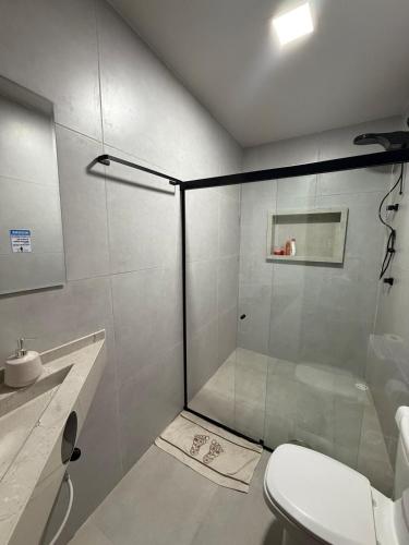 a bathroom with a shower with a toilet and a sink at Casa Massa in Marechal Deodoro