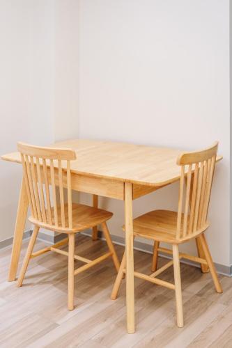 a wooden table and two chairs sitting around it at Dragon's Keep BNB near NAIA and MOA in Manila