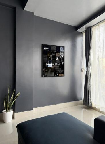 a living room with a wall with a picture on it at Noir Suites in Patna