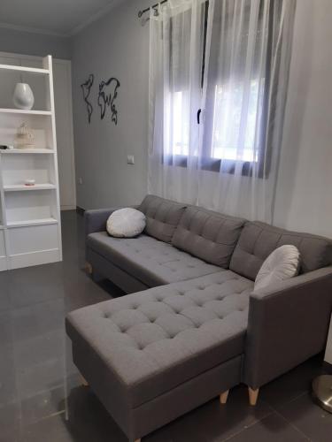 a living room with a couch and a window at LOFT La Placeta in Enguera
