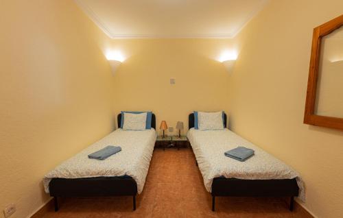 a room with two beds in a room at Casa Panorama in Chefchaouen
