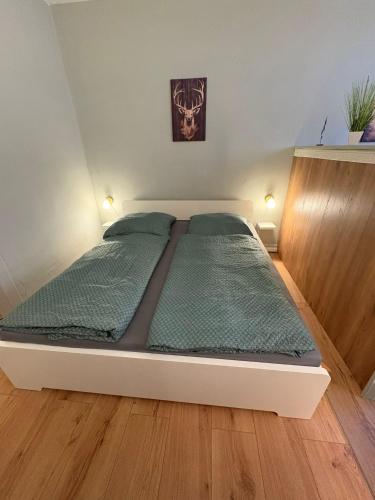a large bed in a bedroom with wooden floors at Appartement Königshütte in Königshütte