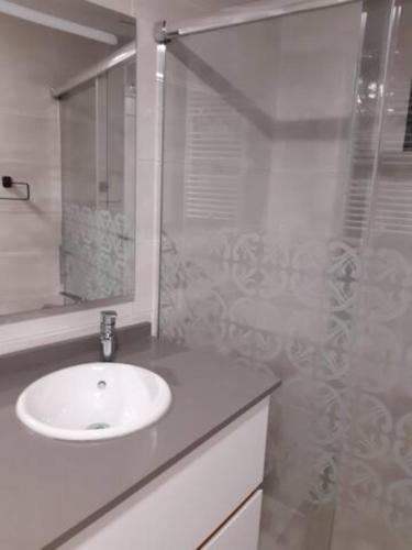 a white bathroom with a sink and a shower at LOFT La Placeta in Enguera