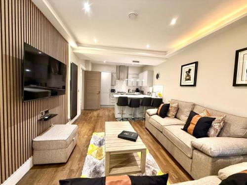 a living room with a couch and a table at Ultra Modern, Stylish Apartment Next To Princes St in Edinburgh