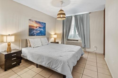 a bedroom with a large bed and a window at Beachfront Aquatika Resort- Style-Pools & Ocean in Rio Grande
