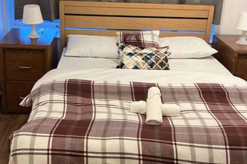 a bed with two stuffed animals on top of it at 3 Bed House Sleeps 5 - Free Parking - Tv & WiFi in Sheffield