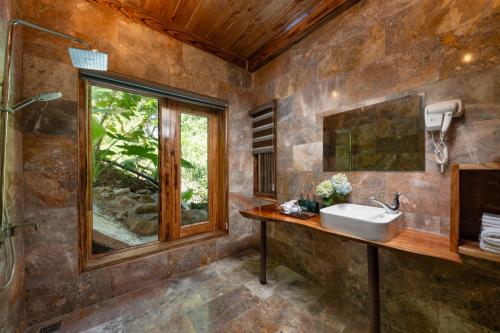 a bathroom with a sink and a window at Asia Tropical Resort and Spa in Làng Coc
