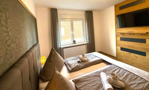 a room with a bed with a teddy bear sitting on it at Ferienwohnung Auszeit Norddeich I 5 Minuten zu Fuß zum Meer in Norddeich