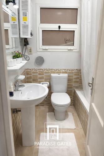 a bathroom with a white toilet and a sink at Paradise Gates Madinaty in Madinaty
