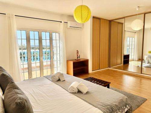 a bedroom with a large bed with two towels on it at Casa da Eira - Private Villa - pool - Free wi-fi - Air Con in Silves