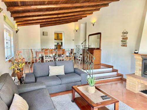 a living room with a couch and a fireplace at Casa da Eira - Private Villa - pool - Free wi-fi - Air Con in Silves