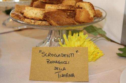 a plate of food with a sign on top of it at Hotel Sogno in Cesenatico