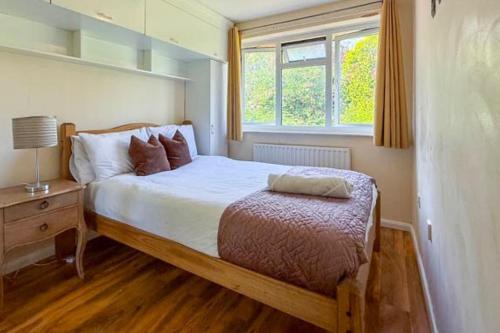 a bedroom with a large bed and a window at House Sleeps 5 - WiFi & Tv in Luton