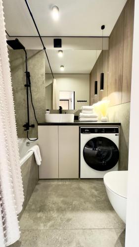 a kitchen with a washing machine in a bathroom at MOLODIST 16 Irpin in Irpin