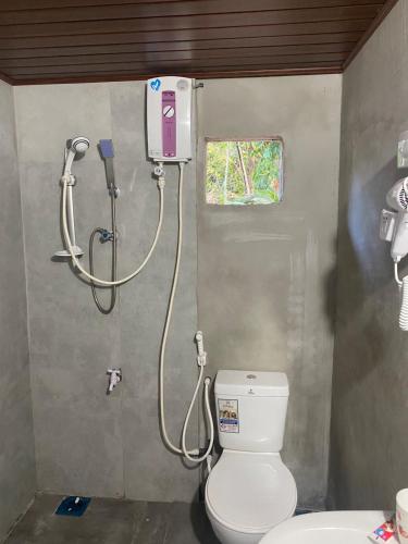 a bathroom with a toilet and a shower at The Ceylon Olive Resort in Katunayaka