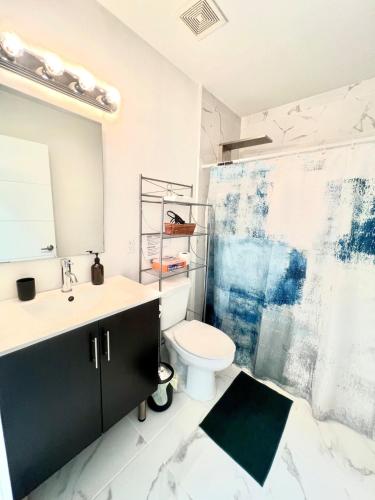 a bathroom with a sink and a toilet and a shower at Studio Apartment with backyard - All Private! in Homestead