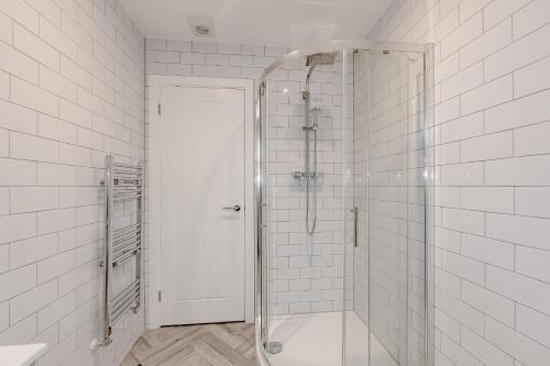 a shower with a glass door in a bathroom at Studio Room, Parking, Contractors and Relocators, Weekly Deals in Maidstone