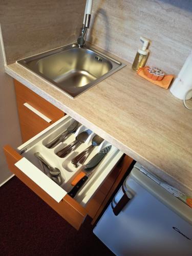 a kitchen counter with a sink and a drawer at Ubytování u Macochy in Vilémovice
