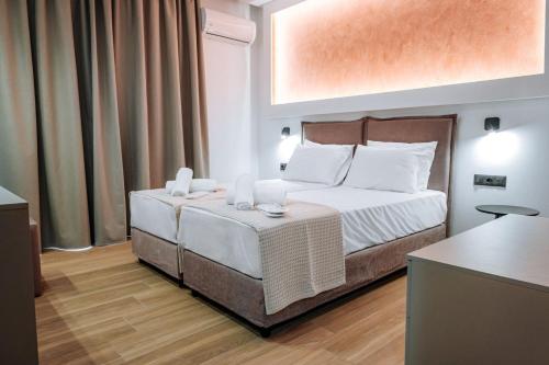 a hotel room with a bed and a table at ILIADA Boutique Rooms in Faliraki