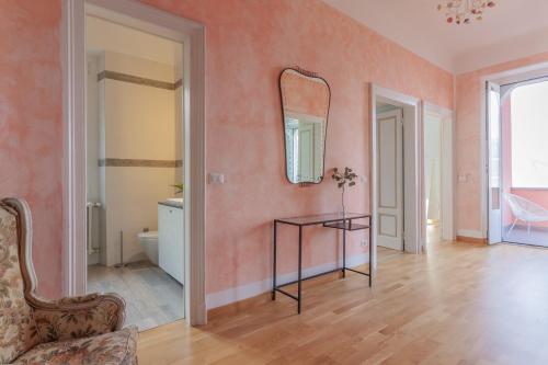 a living room with a table and a mirror at Villa La Perledina in Perledo