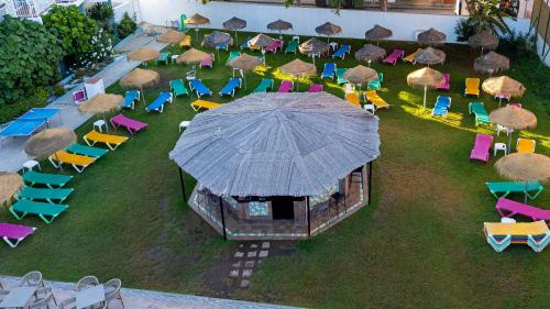 an aerial view of a group of chairs and an umbrella at MedPlaya Hotel Alba Beach in Benalmádena