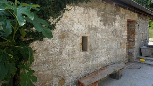 a stone building with a bench in front of it at Casa dei Moch in Belluno