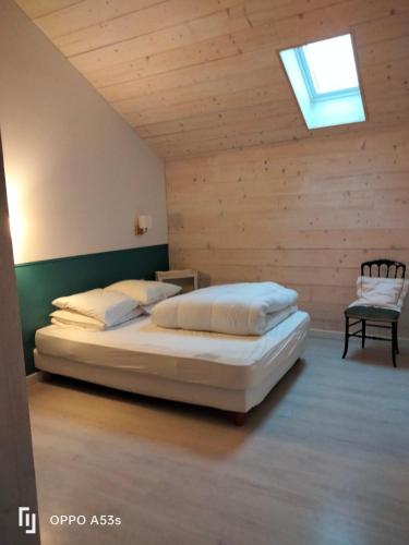 a bedroom with a bed and a skylight at Bordeneuve in Le Passage