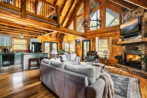 a living room with a couch and a fireplace at Family Haven by Dollywood - Hot Tub - Game Room in Pigeon Forge