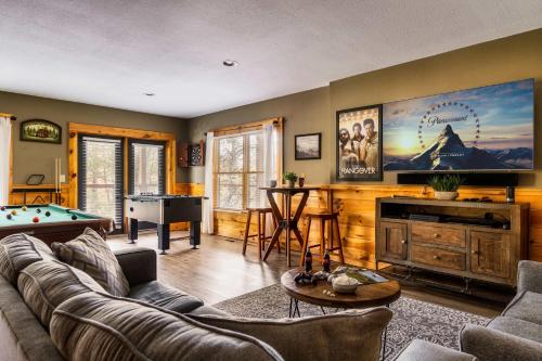 a living room with a couch and a pool table at Family Haven by Dollywood - Hot Tub - Game Room in Pigeon Forge