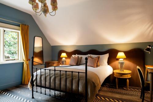 a bedroom with a large bed and a window at Bull Inn in Reading
