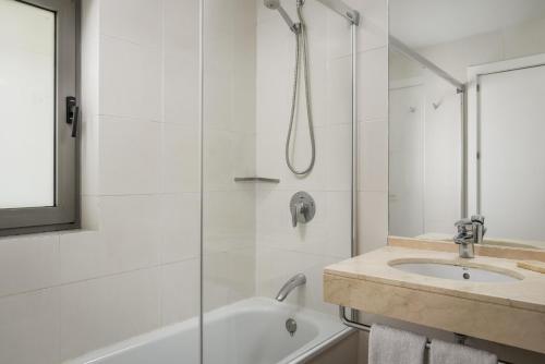 a bathroom with a shower and a sink at BYPILLOW Tiento in Cádiz