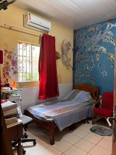 a hospital room with a bed and a window at Chalé Santarém, located in Mosqueiro! in Belém