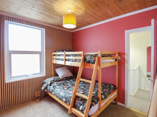 a bedroom with two bunk beds and a window at Meregate Cottage in Margate