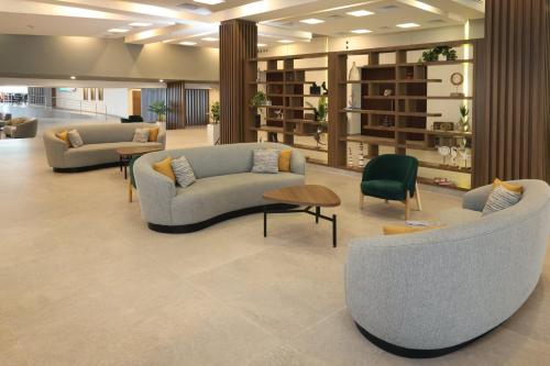 a lobby with couches and chairs in a building at Holiday Inn Veracruz-Boca Del Rio by IHG in Veracruz