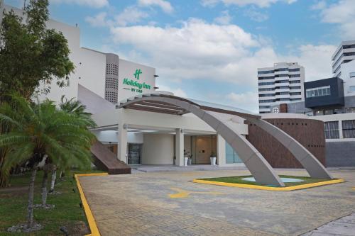 a building with a metal arch in front of it at Holiday Inn Veracruz-Boca Del Rio by IHG in Veracruz