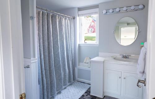 a bathroom with a shower curtain and a sink at Exceptional Contemporary Retreat with 4 King Beds in Mystic CT in Groton