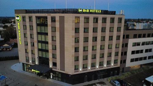 a large building with a sign on top of it at B&B HOTEL Warsaw East in Warsaw