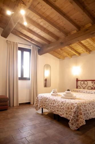 a bedroom with two beds and a window at Il Casale Naturart in Quarrata