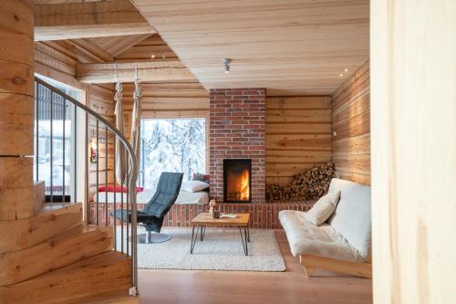 a living room with wooden walls and a fireplace at Handcrafted Log Chalet Villa Aarreaitta in Syöte