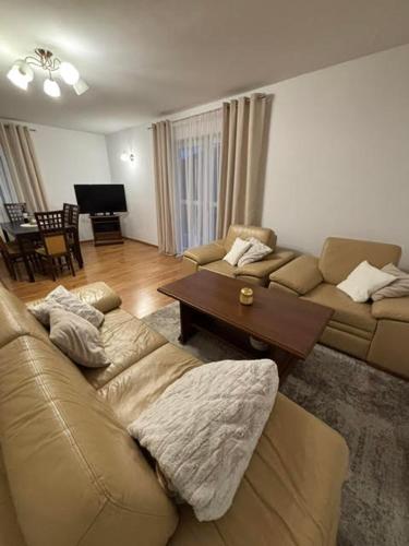 a living room with a couch and a table at Domek nad Sołą in Cisiec
