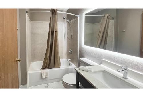 a bathroom with a sink and a toilet and a mirror at Studio 6 Mobile AL in Mobile