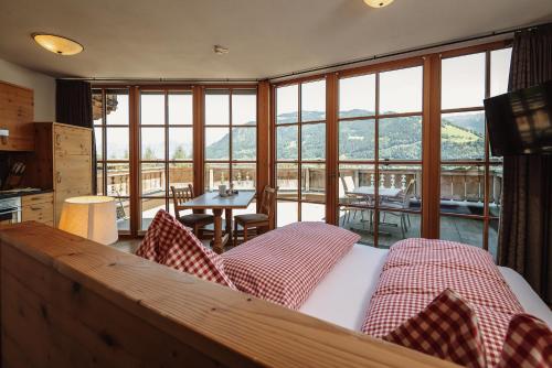 a bedroom with a bed and a large window at Berg- & Seeblick Pfefferbauer in Zell am See